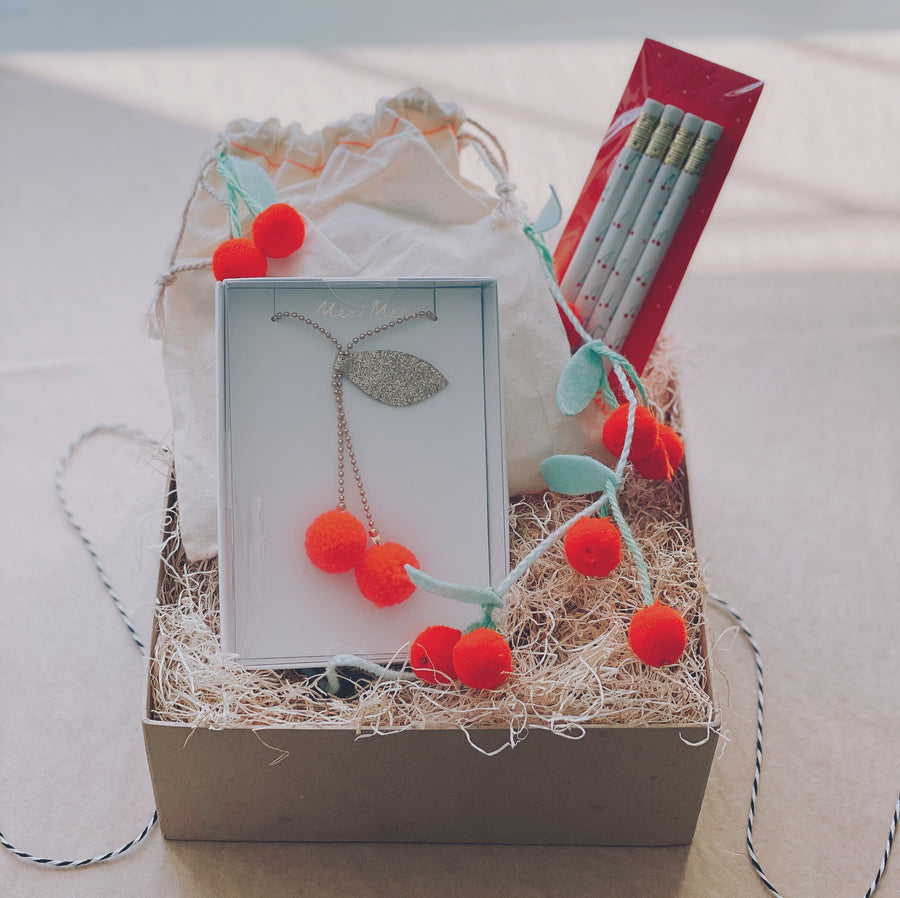 cherry on top gift box with a meri meri cherry garland and cherry necklace and a set of mr boddingtons pencil | piper & chloe